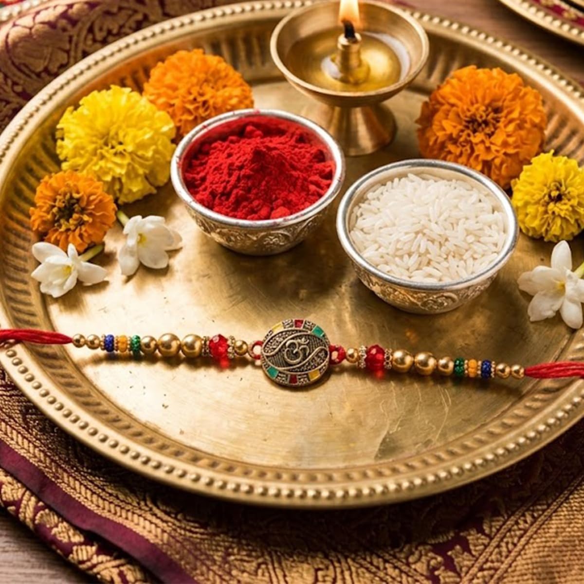 Om Rakhi for Brother with Chocolate and Mahakal Metal Key Chain with Roli Chawal Chopra Om Rakhi for Brother with Chocolate and Mahakal Metal Key Chain with Roli Chawal Chopra