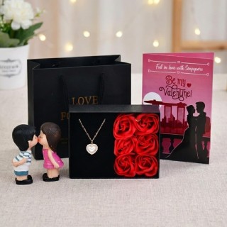 Valentine Gift Combo for Girlfriend - Red Roses with Love Pendant, Greeting Card, Kissing Couple Showpiece and Carry Bag